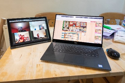 Dell XPS 15 laptop open beside Surface Pro showing screen and precision touchpad