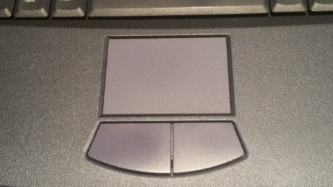 Laptop touchpad surface close-up showing precision pointing device area and click zones