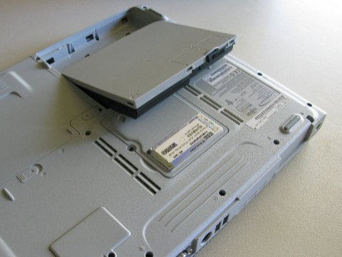 Laptop PC with battery ejected showing Power Bridge dual battery removal reset