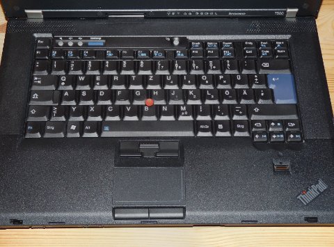 Lenovo ThinkPad keyboard showing red TrackPoint stick and middle scroll button