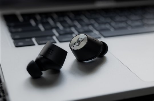 Wireless earbuds on HP Pavilion gaming laptop keyboard