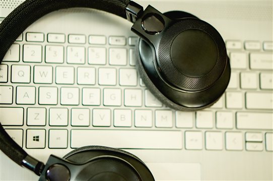 Black headphones resting on HP Pavilion gaming keyboard